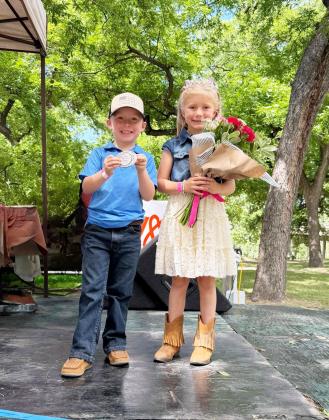 JIM BOWIE DAY ROYALTY- A popular holdover from the original Jim Bowie Days is the Little Mr. &amp; Miss Silver Nugget contest. Youngsters are interviewed on stage and judges determine the winners. This year’s titles go to Waylon Fairless (5) and Anna Jo Hicks (6), both grandchildren of Paige and Johnny Hicks of Menard. Additional coverage of the weekend festivities will be included in next week’s newspaper. Chamber photo.