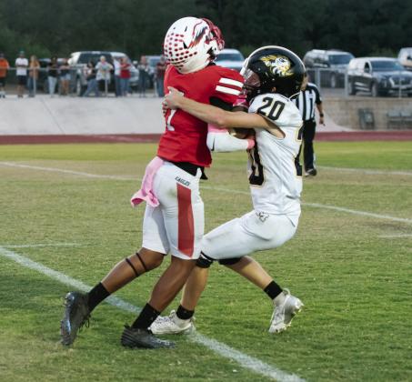 Bryce Davis (#20) wraps up his mark during the Jackets’ district win over Leakey on Friday. Davis’s performance earned him Yellowjacket Defensive Player of the Week.