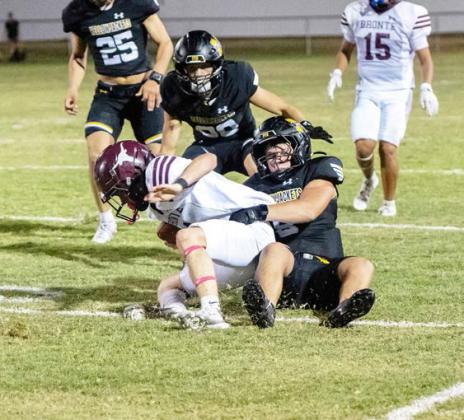 Mack Davis brings down a Bronte Longhorn during the Jackets’ home game on Thursday, Aug. 27, 2026. Davis also completed an 11-yard touchdown in the 60-0 win. Wesley Compton (25) and Hunter Squiers provide backup.