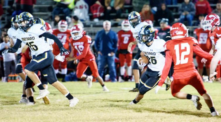 CAN’T CATCH ME! Senior Yellowjacket Orlando Resendiz, #25, picks his way through the Rocksprings defenders as he runs back a kickoff to score a touchdown, one of two TDs for #25 that evening. Teammate Joel Guerrero, #15, helps block for him. Resendiz ran back two Angora kickoffs to score in both the first and third quarters. Nora Davis, photo.