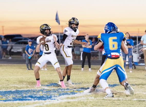 Under the watchful protection of sophomore Jayden Payton, junior Logan Powell (8) steps back to find a receiver during last week’s district game in Veribest. The Yellowjackets lost the game, 58-8. “We have to find better ways to come out and compete and give ourselves a better chance early in games,” said head coach Bryson Oliver.