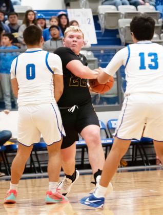 A WELL EARNED CHARGE- Photographer Nora Davis captured this succession of senior Yellowjacket Tate Wagner, center, bulldogging an Eden Bulldog on his way to the basket during the Jackets' loss to Eden last week. In order to claim a share of the district title, the Menard boys must win their last 2 regular season games against Rochelle and Panther Creek. Nora Davis, photos.