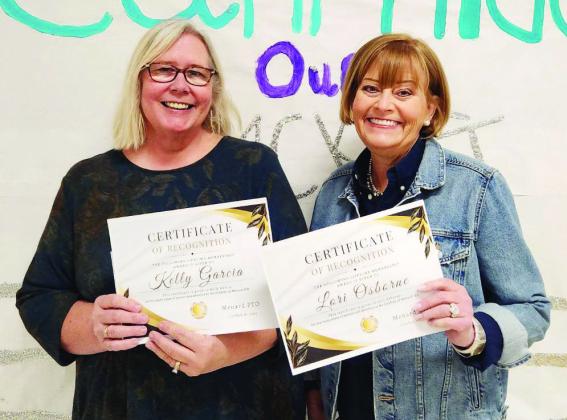 Veteran teachers Kelly Garcia (l) and Lori Osborne (r) accept PTO Lifetime Membership Awards for their dedicated years of service to Menard students and PTO. Courtesy Photo.