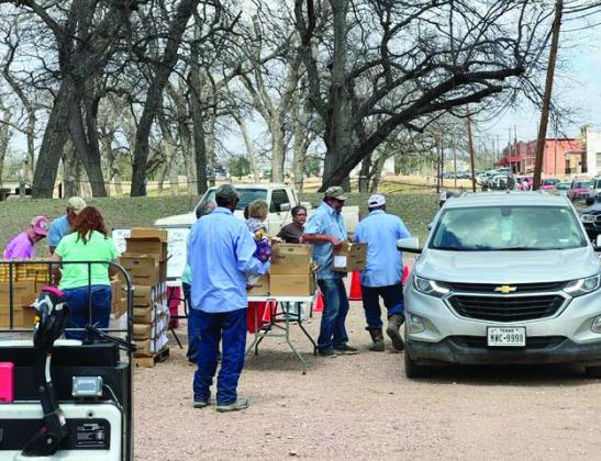 ABOVE- City employees and several community volunteers worked hard to pack and distribute grocery staples to more than 150 families. San Antonio Food Bank provided the food. TMN photo.