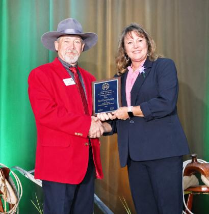 LEFT- National Association of County Agriculture Agents (NACAA) President J.J. Jones presents Menard County AgriLife Extension Agent Lisa Brown with one of the industry’s highest honors, the Distinguished Service Award. Courtesy photo.