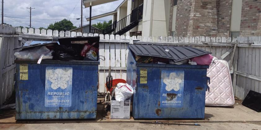 Trash was found stacked between and behind overflowing dumpsters at the Deer Creek and Silver Trail Apartment complexes. Both complexes to press charges if perpetrators are identified. Michael Owen photo.