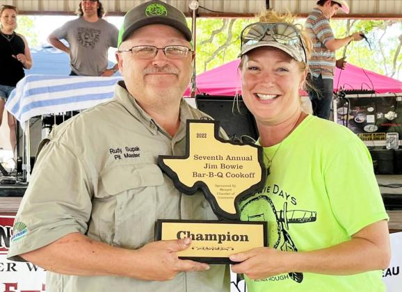 WINNER, WINNER, BBQ DINNER- Rudy Supak of Junction braved the heat last Saturday and was awarded overall Grand Champion of the Jim Bowie Day BBQ Cookoff. Board member Kimberly Powell, right, presents Supak with his plaque. Courtesy photo.