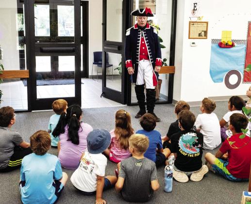 In a file photo, Colonel Terry Kelley (RET) volunteers during a summer reading activity last summer. The summer reading program is always free of charge and will start in June.