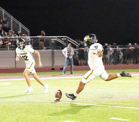 Dario Gonzalez, with River Salas nearby, kicks off during the Jackets’ 59-14 win over Zephyr last Friday. Gonzalez was 5/5 on PATS and added 4 touchbacks.