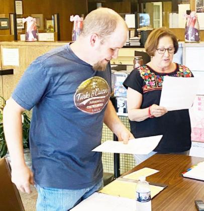 Tyler Wagner and Barabara Hooten read aloud their oaths of office and were then sworn in to their incumbent positions on Monday, May 9.