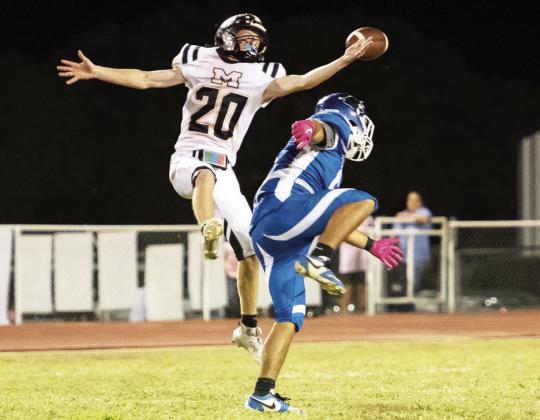 Yellowjacket Bryce Davis, a junior, leaps up for an interception against the Nueces Canyon Panthers in Menard's 82-54 win last week. The Jackets are 3-0 in district play. They are open this week, then face Eden at home to complete district next Friday, November 8. Nora Davis, photo.