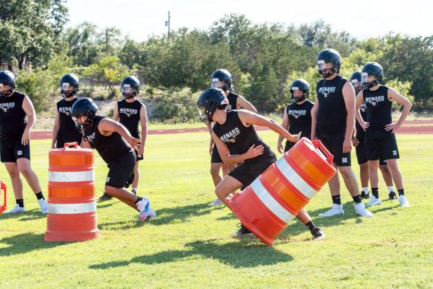 ON THE MOVE- Juniors Zeke Hernandez and Cado Bannowsky work through some barrel drills during a summertime Jacket football practice. The team will brave hot temperatures Thursday afternoon to host Panther Creek and Gorman beginning at 6. Nora Davis, photo.