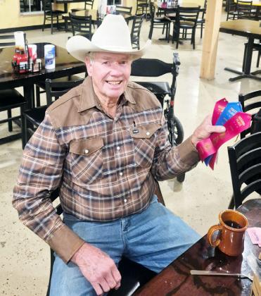 ABOVE- Bill Doyle displays his awards from December’s Menard County Pecan Show. BELOW- John, Barry and Billy Kniffen, along with Bill Doyle, tend to business during the 2025 county pecan show. Courtesy photos.