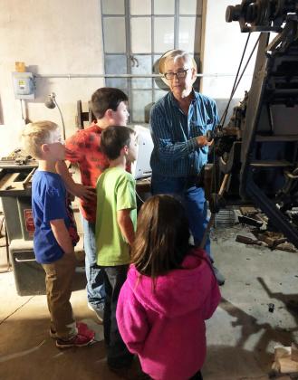 ABOVE- Dan never fully stepped away from the news office upon retirement, whether we suggested it or not. Above he is explaining the original printing equipment to some elementary Gifted &amp; Talented students in 2018. Those kids are juniors in high school now- Kinsley Carlile, Benjamin Burch, Wesley Compton, Noble Porter. TMN photo.