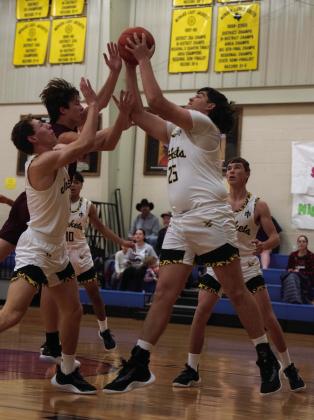 Freshman Ayden Ramon (25) and Senior Wyatt Terrell fight for the ball in Tuesday’s game against Bronte.
