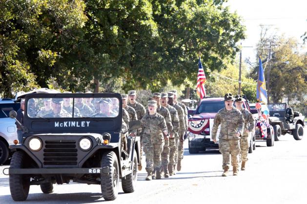 LEFT RIGHT LEFT- The Goodfellow AFB Charlie Co. 344 MI Battalion traveled from San Angelo to help lead Saturday’s annual PTO Veterans Day Parade in Menard. Capel. Sager from Eden (driver), and RET/COL Terry Kelley (left, passenger) fall into the parade procession behind the Girl Scouts as leaders. Nora Davis, photo.