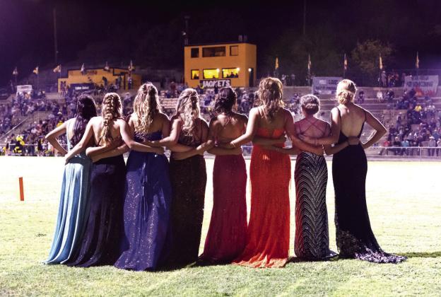 GO JACKETS! Candidates cheer on their team as they wait patiently for halftime. Left to right: Nadia Garcia, Kaitlyn Whitaker, Cozette Halley, Ileana Baker, Hailey Ruiz, Makinley Kothmann, Aminy Anderson, and Addy Bannowsky.