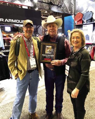 Gary and Deb Roberson, middle and right, owner/operator of Burnham Brothers won SHOT Show 2024 Mouth Blown Call of the Year presented by Gordy J. Krahn of Predator Xtreme magazine. Courtesy Photo.