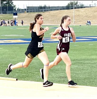 Freshman Kendal Lawler, left, strides past an opponent during the 3200m run at the Region II-A track meet in San Angelo on Saturday, April 30. Lawler placed 15th in her race. Courtesy photo.