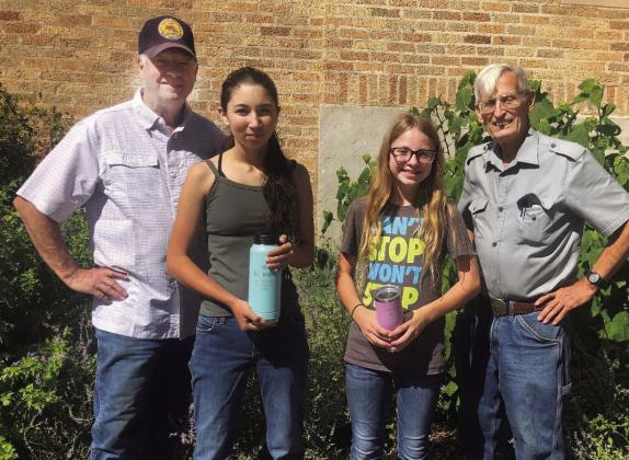 SHARP SHOOTERS pictured (L to R) Shooting coach Terry Kelley; Top Intermediate Shooter Mia Estrada; Most Improved Junior Shooter Isabelle Devine; coach David Hand. These awards were initially presented at the 4-H Awards Banquet; the recipients were unable to attend. Courtesy Photo.