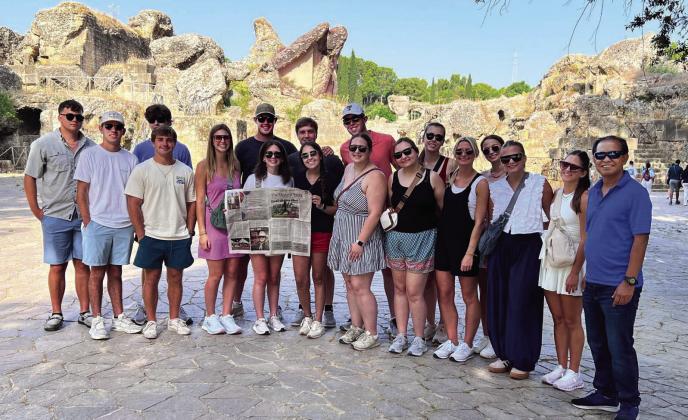Texas Tech University Agricultural and Applied Economics students pictured reading the Menard News at the Italica Roman ruins in Spain are: (l to r) Hunter Dinkins, Stayton Haegan, Justin Moore, Tristan Robin, Kyndal Edwards, Jay Grimsley, Brinley Lippincott, Tim Ally, MHS 2023 grad Aminy Anderson, Wes Shaw, Campbell Bednar, Shylee Gulley, Madi Talkington, Heather McNabb, Caroline Munson, Braelyn Pointer, Kirsten Beznar, and Dr Shaikh Rahman.