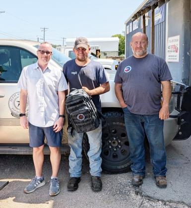 Richard Moreland, left, with Texas DisasterLink presents MVFD Chief Tyler Wagner and Menard County Emergency Management Coordinator Jeff Whitson with communication equipment and services to maintain connectivity for first responders during emergencies. Courtesy photo.
