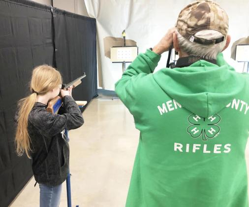 SHARP SHOOTER- Coach David Hand spots the shots of Isabelle Devine during the 2022 Texas BB Gun Championships in Brady last weekend.