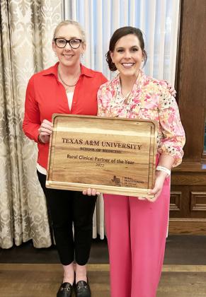 Frontera Executive Director Mikki Hand, right, accepts the clinic's rural medicine award. Courtesy photo.