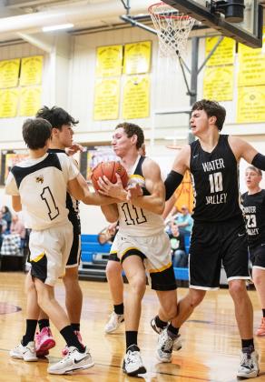 Senior Roy Brown (1), and junior Wyatt Terrell (11) fight for the ball in the Yellowjackets’ meet-up with Water Valley.