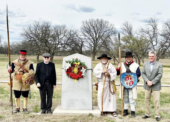 MEMORIAL WREATH- A wreath from the Menard County Historical Commission was placed at the San Saba Mission site to commemorate the 265th anniversary of the destruction of the Mission. Pictured left to right: “Soldado” Scott Jones; Father Mark Woodruff; “Fray Molina” (Joe Gonzalez); “Soldado” Gus Martinez, Mark Wolf. Courtesy photo.