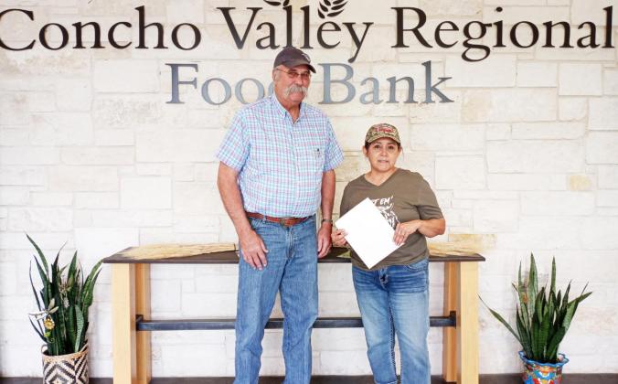 Cindy Alvarado (right), Executive Assistant for the Concho Valley Regional Food Bank accepts a check from Charles Anderson, Menard Branch 161 President. The funds donated to the food bank will allow them to purchase approximately 1,000 pounds of food. Courtesy photo.