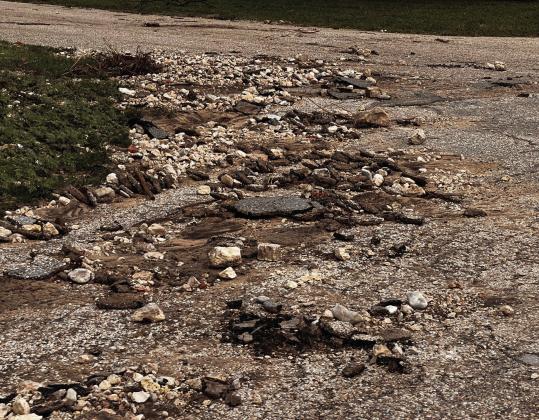 Road debris, as pictured above on Wilkinson Street, can be found on many streets throughout town. A city bond election held in 2019 — which proposed to chip and sealcoat all city streets, improve drainage systems, and make other street-related improvements within the city limits — failed to pass. City road crews will be working to repair streets, as soon as, weather allows. TMN photo.