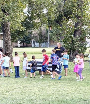 RIGHT- MCSO Deputy Dorothy Baker enjoys the beautiful weather Tuesday night at the Menard County National Night Out, held on the courthouse lawn/American Legion Park. The event is annual and nation-wide, and allows local residents a chance to get to know an interact with law enforcement and first responders. Chamber photo.