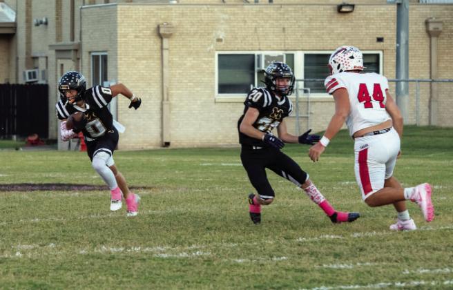 'I'LL TAKE THAT' says junior Hunter Squiers (#0) after nabbing his fourth interception of the season in Menard's 59-0 district win over Leakey last week. Senior Bryce Davis (#20) provides a block. The Jackets are now focused on Medina, where they will be on the road this Friday. See additional football photos thanks to our Jacket Backers on page 8. Nora Davis, photo.