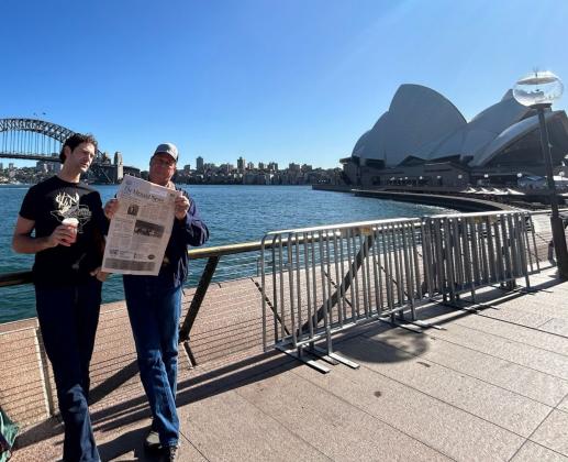 John Davis (r), the philanthropic owner of The Menard Station and Pecan Spring Ranch, and son Samuel Davis (l) kept up with news in Menard via The Menard News on a recent trip to Sydney, Australia. Courtesy Photo.