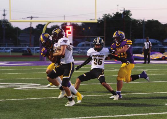 Yellowjacket Joel Guerrero, a junior, fights his way against an Ozona Lion on Friday, September 17. Senior Orlando Resendiz, #25, blocks an Ozona player. Menard came up short against Ozona, 6-70. Photo by Nora Davis.