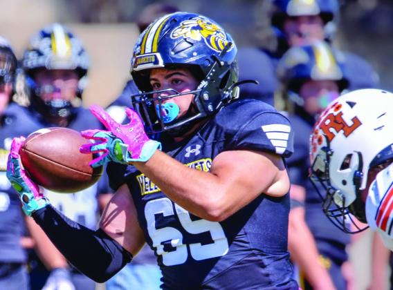 Senior Jadon Torres gets a hold on the ball during the Yellowjackets first district game against Robert Lee.