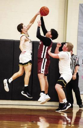 Menard's Wyatt Terrell, left, joins teammate Tate Wagner to shut down a Paint Rock shooter during the Jackets' win over Paint Rock last week. See page 7. Sandy Kothmann, photo.