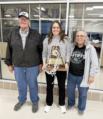 GIRLS BASKETBALL COACH OF THE YEAR Kami Williamson, center, is pictured with her parents John and Nancy Williamson of Menard after a playoff win by Coach K's Class 5A Cedar Park Timberwolves earlier this year. Williamson is a Menard High School graduate who played basketball as a Lady Jacket. She then went on to play for West Texas A&amp;M and ASU before beginning her coaching career. See story on page 3.
