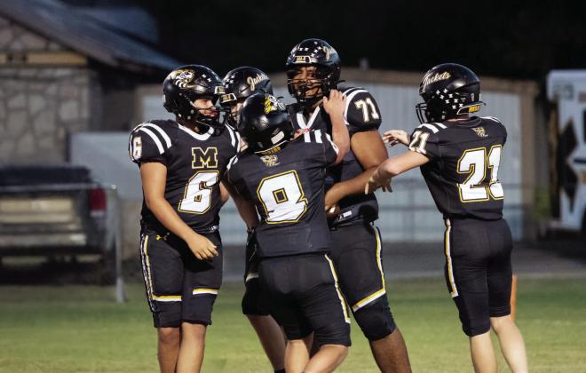 ATTA BOY! JV football teammates Sam Mayfield (6), Mack Davis (8), and Kade Bannowsky (21) congratulate Julian Wat - son (71) on his first career touchdown, scored against Paint Rock at home last Thursday evening. The JV Jackets shut out the Paint Rock Indians 47-0 last week. The varsity (5-0) continued the trend on Friday with their 62-0 win, and the Junior Jackets also got the home win, 48-12. See additional football photos on our Jacket Backer feature on page 8. Photo by Nora Davis.