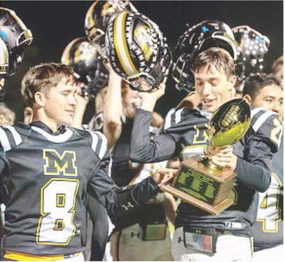 POW POW- Seniors Logan Powell and Colby Powell check out the bi-district golden ball the Yellowjackets secured last week with a 54-7 win over Benavides. The Powell brothers are the only senior Jackets this year, and they will have their work cut out for them leading the team against Gordon in the area playoff on Thursday. Nora Davis, photo.