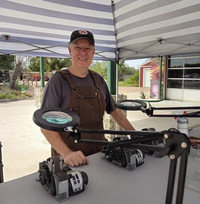 Mark Wilson’s Wilson Sharpening Services “pops-up” in front of The Menard Station. Look for the blue and white striped tent. Courtesy Photo.