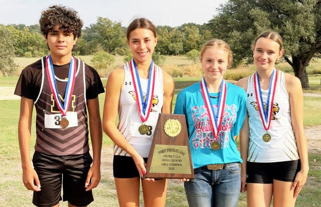 Ian Brown, Danni Ruiz, Isabelle Devine and Aerie Meddaugh display the high school cross country’s hardware from Wednesday district meet in Eden. The group photo is sparse due to half of the athletes leaving quickly after the race to attend the Hill County Youth Commercial Heifer Show as contestants. Laressa Brown, photo.