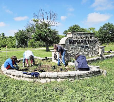 TEAM WORK MAKES THE DREAM WORK for Beautification of Menard projects. Above, volunteers in May work to refresh the landscaping at the city sign just north of the river at the 190/83 intersection. Courtesy photo.