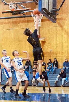 LEFT- Menard senior Colby Powell gets the bucket in a regular season game against Olfen this season. The Jackets are primed to be distrcit champions and will officially secire that title with a win against Rochelle on Friday, Feb. 7. Nora Davis, Photo.