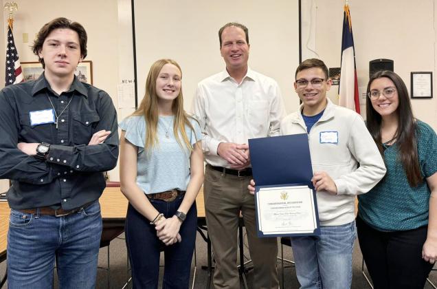 U.S. Congressman August Pfluger was in Menard for a town hall forum last week. Pfluger took the time to present the drum majors and band director a certificate of Congressional Recognition for the group’s second state championship earned in the fall. Pictured are drum majors Aydan Wilson and Cozette Halley, Rep. Plfluger, drum major Kevin Johnson, Ms. Cook, director.