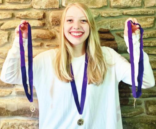AD VICTORIAM- Menard teenager Zea Prest displays her three medals from her three consecutive years of earning Gold Summa Cum Laude distinction in the national Latin Exam. Courtesy photo.