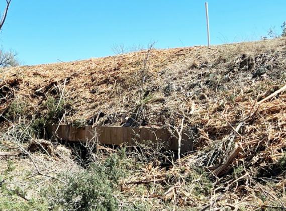 An under-highway drainage culvert near McDougal Draw on SH 29 is one of many drainage channels clogged by shredded cedar and brush. Despite the unsightly mess, landowners have raised concerns over the damage that will occur with the next significant rainfall. TxDOT has stated there is no immediate cleanup planned. Local crews will monitor and respond if property or infrastructure damage occurs. Courtesy photo.