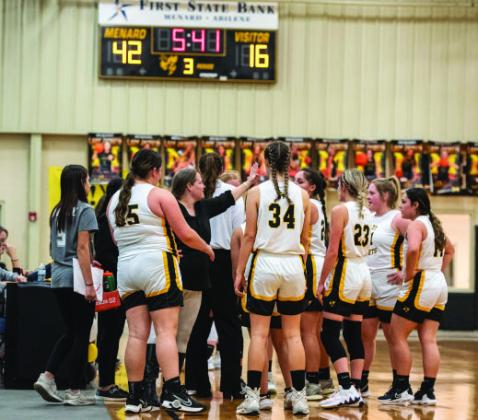 Coach Saller and Coach Bell coach the Lady J’s during the Panther Creek Game under the ‘Jackets 42 to Panthers 16 score board.