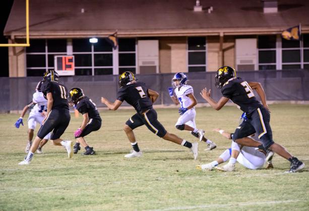 Senior Jay Guerrero (2) carries the ball, with the help of blockers Terrell (11), Rayburn (5) and Stanislawski (30).